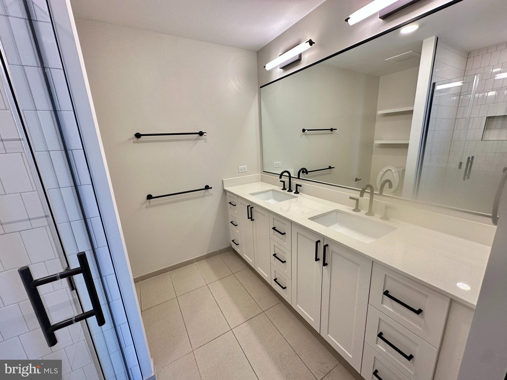 1211 Van Street Southeast, Unit 1201 Washington, DC 20003 - Photo 26 of 58 a bathroom with a double vanity sink and mirror