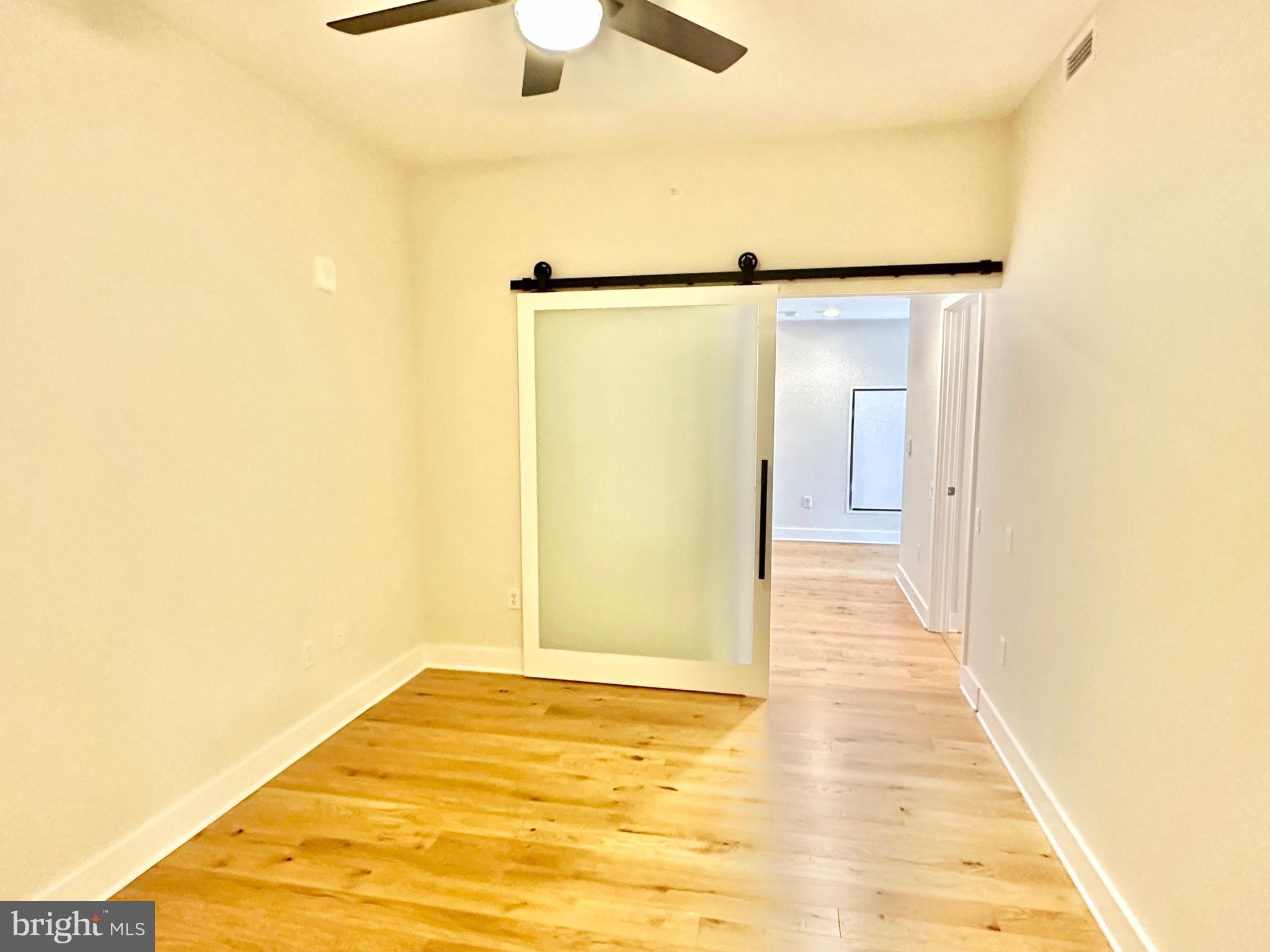 1211 Van Street Southeast, Unit 1201 Washington, DC 20003 - Photo 34 of 58 a view of a big room with wooden floor and chandelier