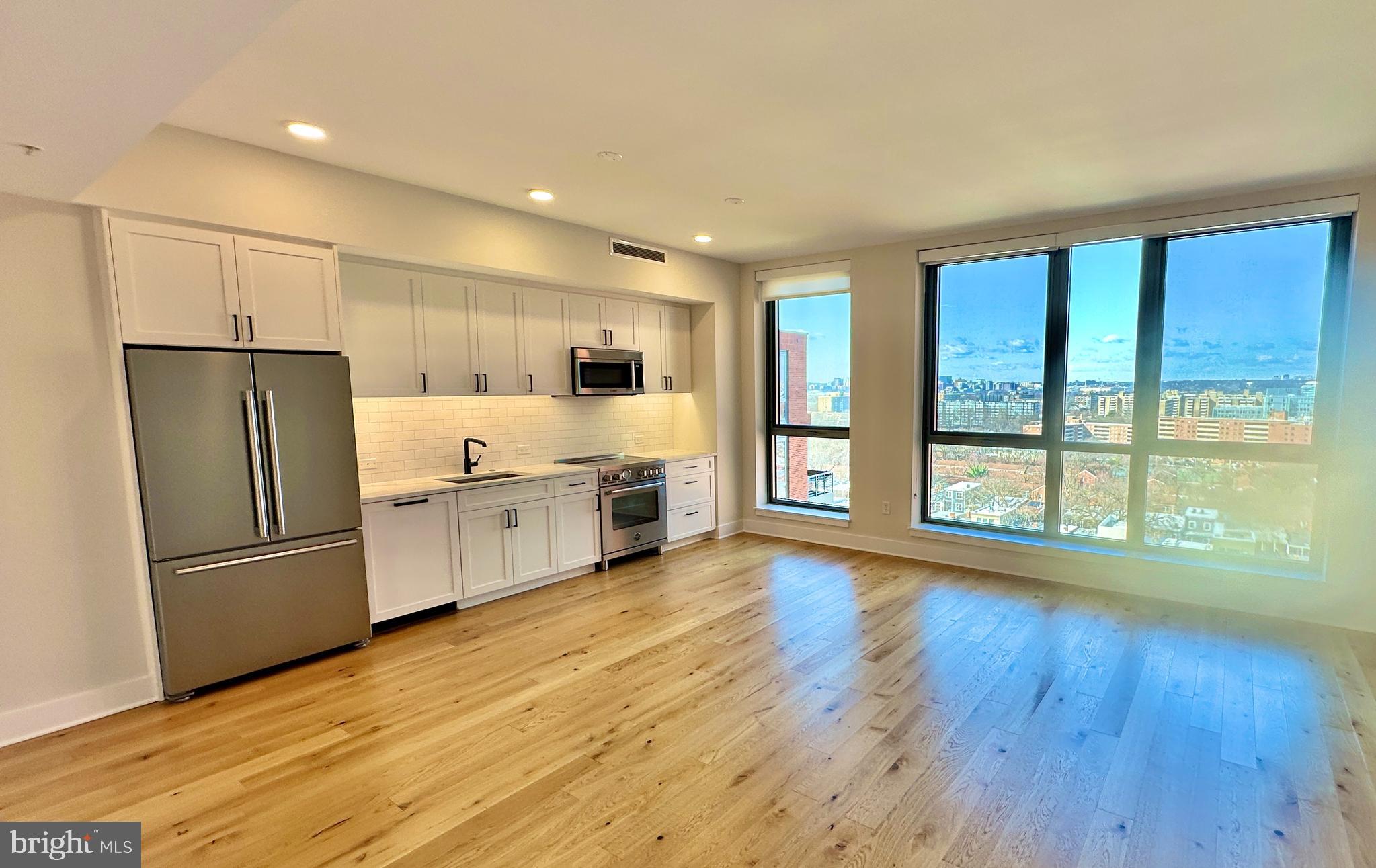 1211 Van Street Southeast, Unit 1201 Washington, DC 20003 - Photo 4 of 58 a kitchen with stainless steel appliances a refrigerator and wooden floor