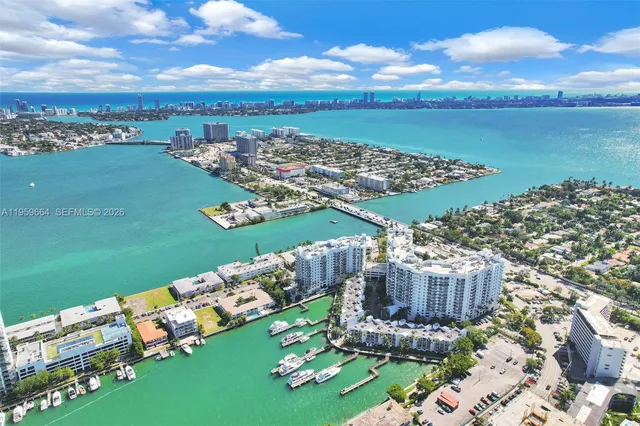 a view of a hallway with wooden cabinets