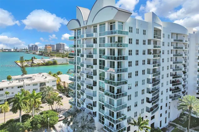 a living room with furniture potted plant and a large window