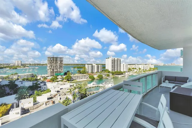 a kitchen with stainless steel appliances granite countertop a sink a refrigerator and a stove