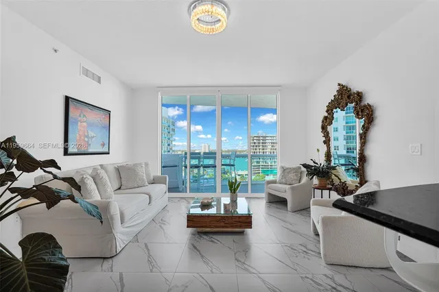 a hallway with white cabinets and wooden floor