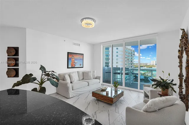 a bedroom with a bed a window and a flat screen television