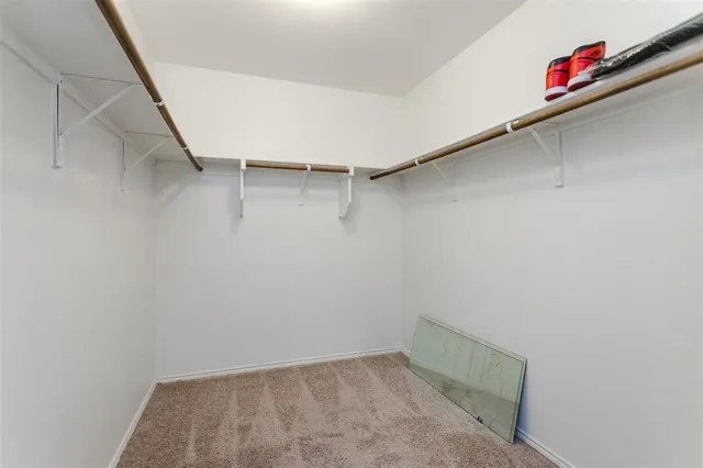 a view of a livingroom with a ceiling fan and window