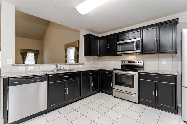 a kitchen with a sink stove and microwave