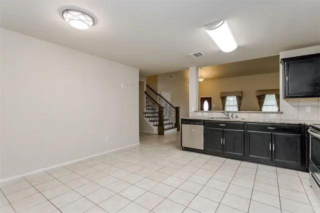 a kitchen with stainless steel appliances a refrigerator sink and microwave