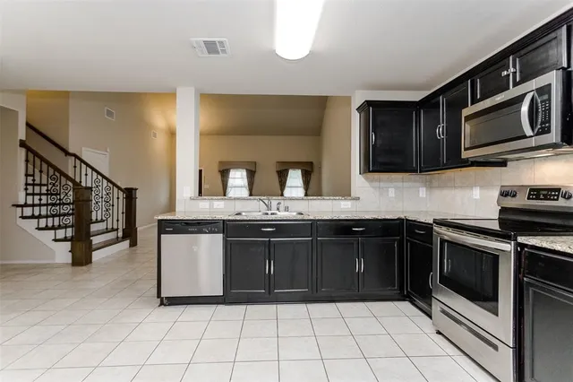 a room with a cabinets and appliances