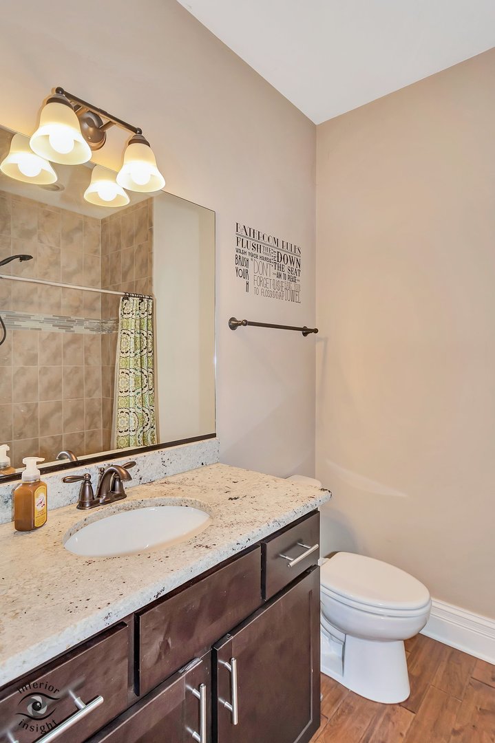 13754 Memorial Drive Manhattan, IL 60442 - Photo 16 of 37 a bathroom with a granite countertop sink a toilet and a mirror