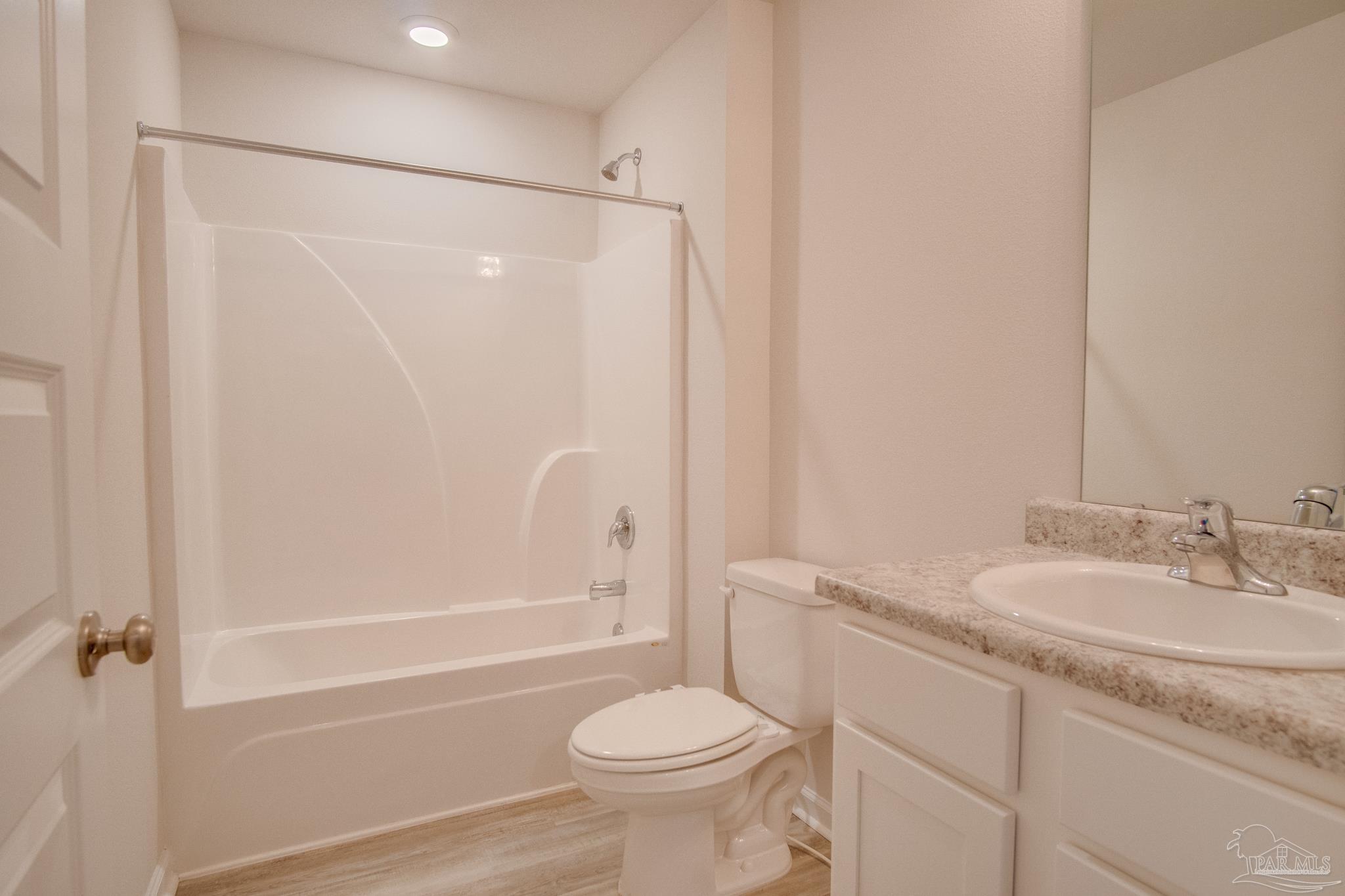 4383 White Cedar Court Pace, FL 32571 - Photo 22 of 36 a bathroom with a granite countertop sink toilet and shower