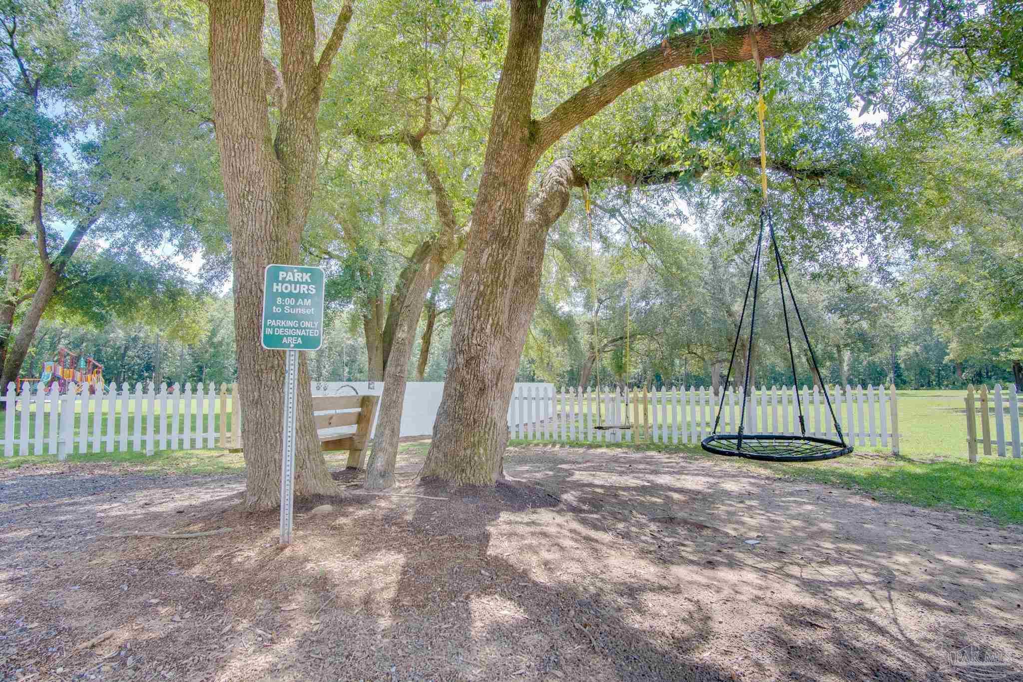 4383 White Cedar Court Pace, FL 32571 - Photo 33 of 36 a view of outdoor space with deck and trees