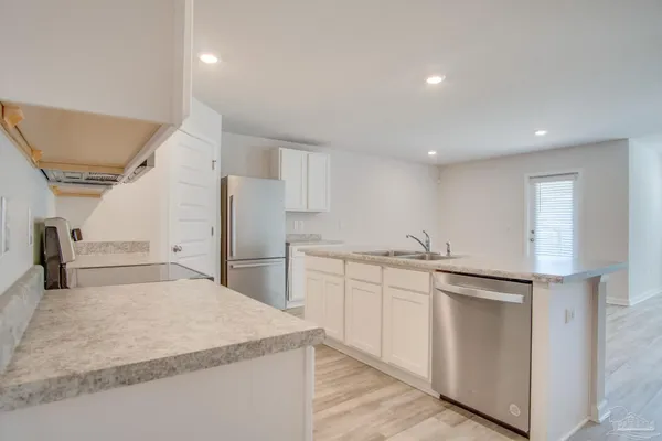a kitchen with kitchen island a sink and a granite counter tops