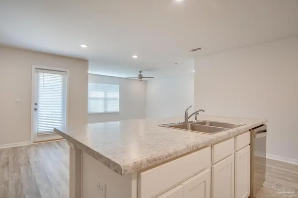 a kitchen with stainless steel appliances granite countertop a sink and a stove