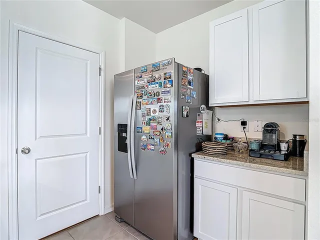a dining room with furniture a chandelier and window