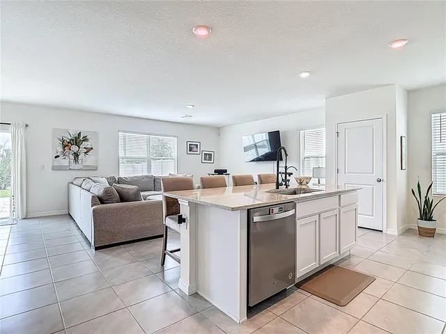 a dining room with furniture and a flat screen tv