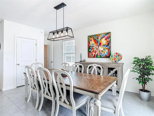a living room with furniture and a dining table with kitchen view