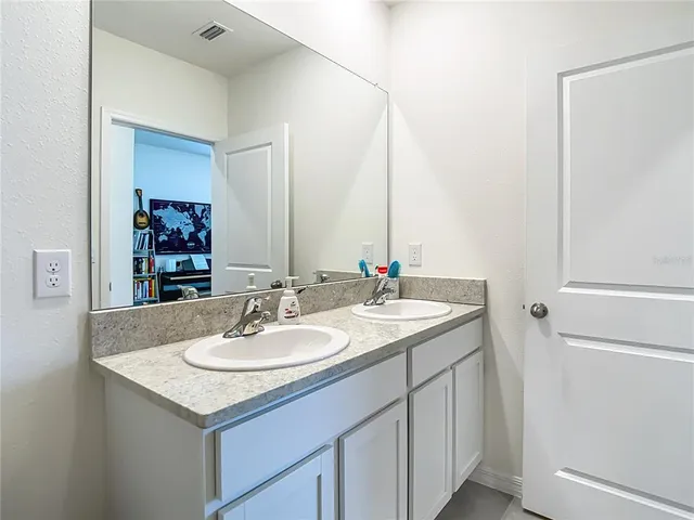 a spacious bedroom with a bed and a window