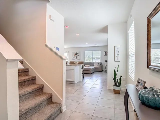 a view of entryway and hall with wooden floor