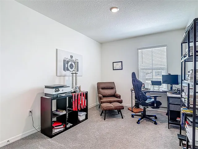 a bedroom with a bed lamp and a window