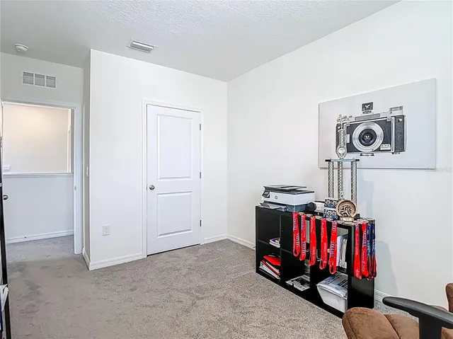 a view of walk in closet with clothes