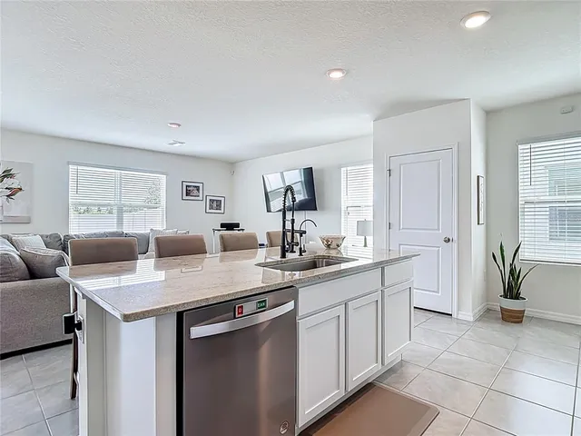 a kitchen with stainless steel appliances white cabinets and a refrigerator