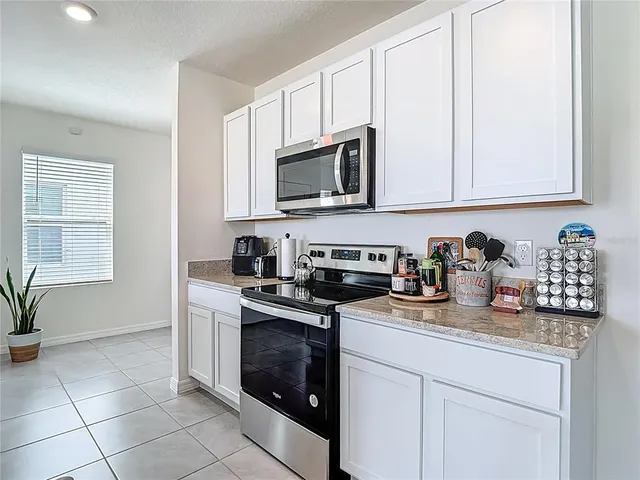 a living room with a sink and cabinets