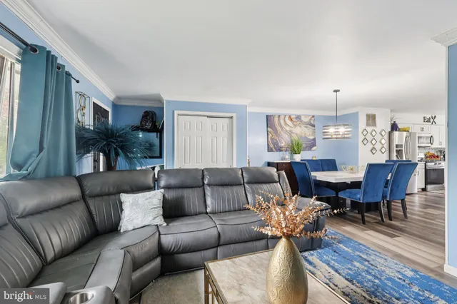 a living room with furniture kitchen view and a dining table