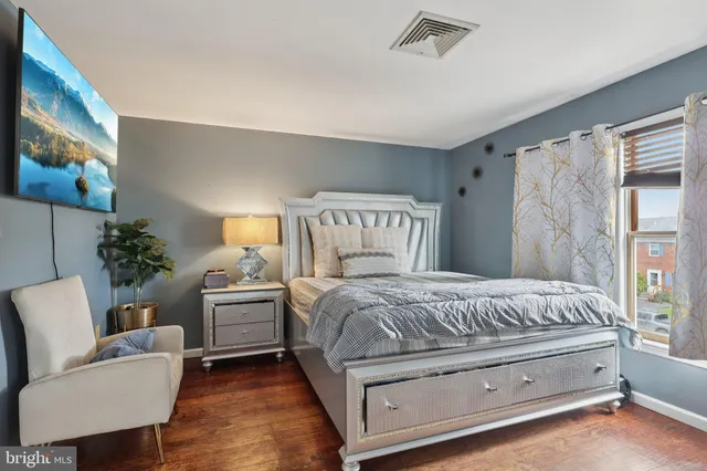 a bedroom with a bed and a chair