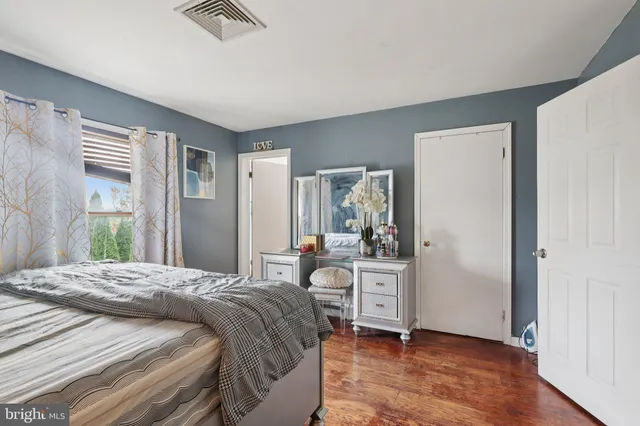 a bedroom with a bed and a dresser