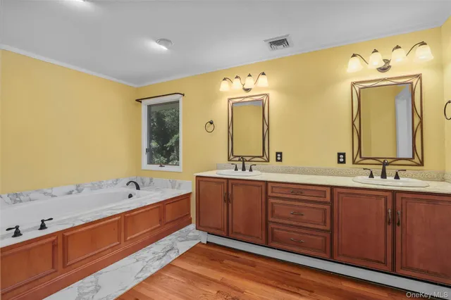 an empty room with a wooden floor and window