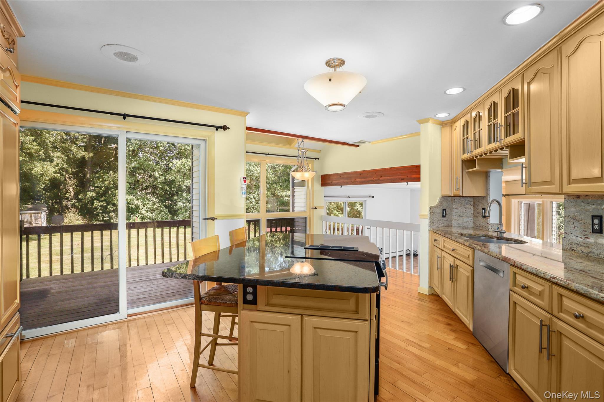 30 Eddy Road Verbank, NY 12585 - Photo 8 of 31 a kitchen with stainless steel appliances granite countertop a stove top oven a sink dishwasher a dining table and chairs with wooden floor