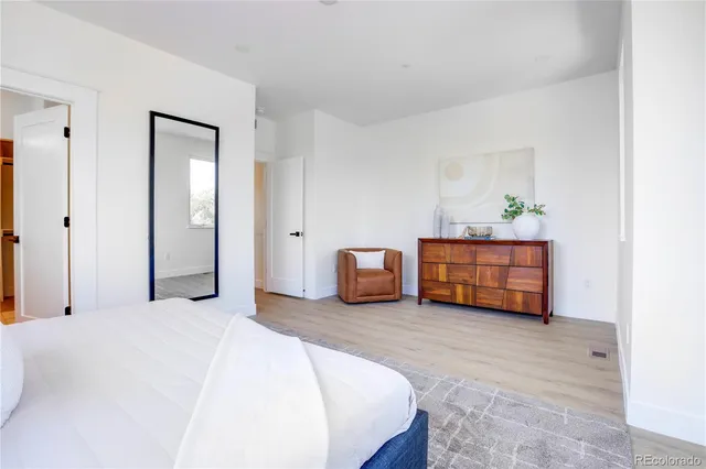 a bed room with furniture and a lamp