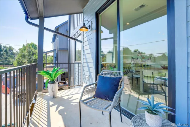a view of balcony with a potted plant and glass door