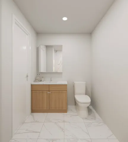 a bathroom with a granite countertop toilet and a sink