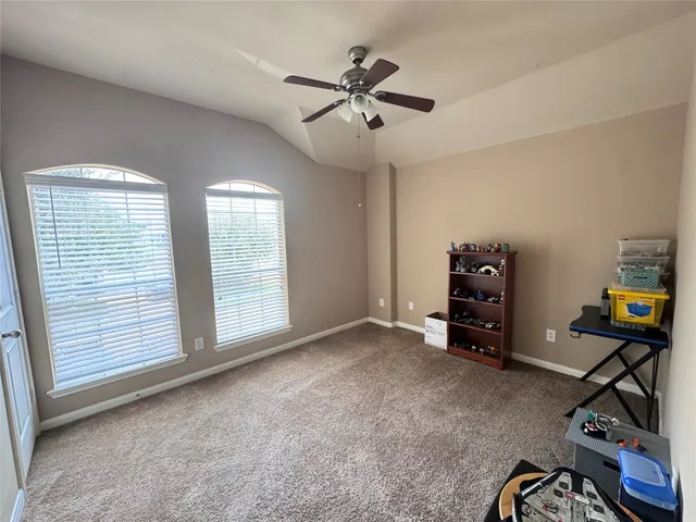 a view of room with workspace and windows