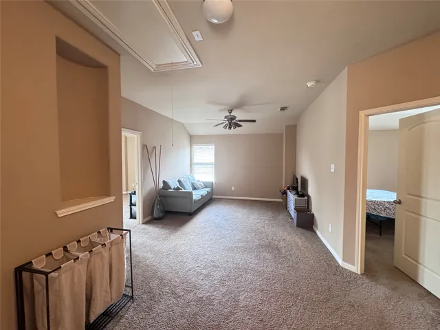 a view of a livingroom with furniture and a ceiling fan