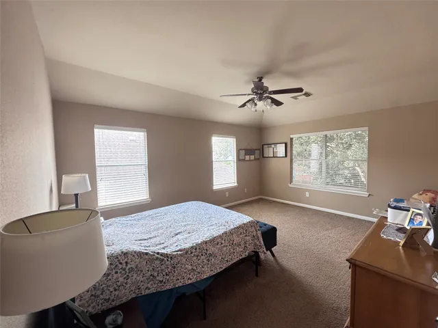 a bedroom with a bed window and a table