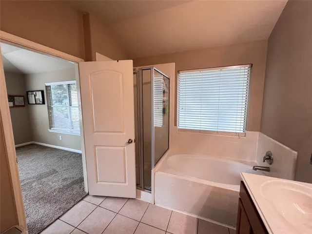 a bathroom with a bathtub and a shower