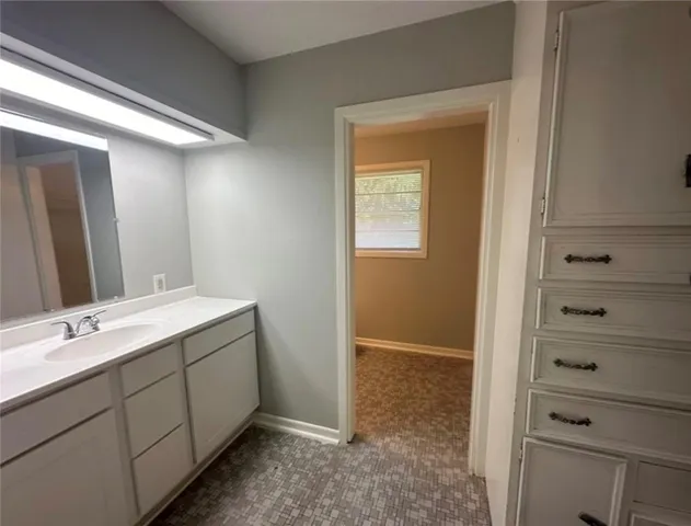a bathroom with a double vanity sink and mirror