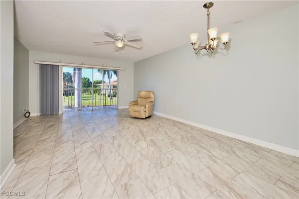 a view of livingroom with a window and furniture