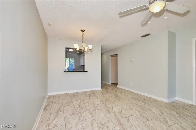 a view of a chandelier in big room and chandelier