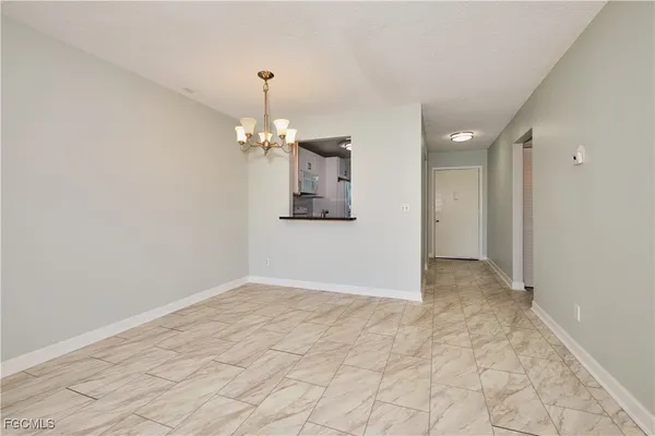 a view of a hallway with chandelier