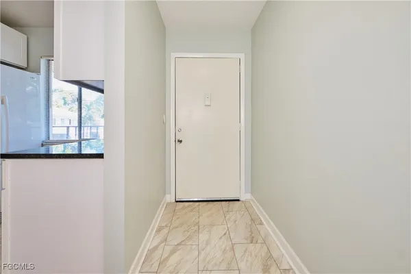 a view of a room with wooden floor and windows