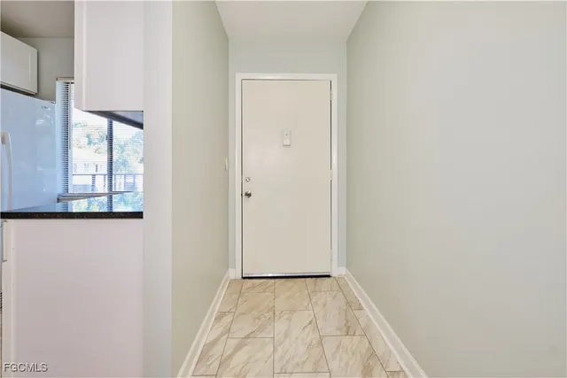 a view of a room with wooden floor and windows