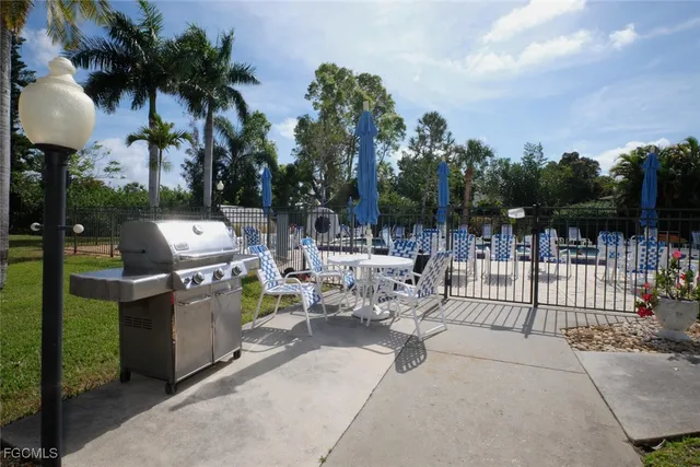 a view of a patio with chairs and a fire pit