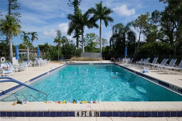 a view of swimming pool with a patio and a yard