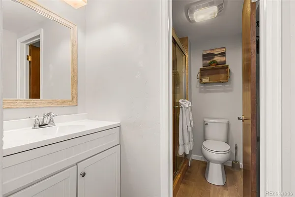 a bathroom with a toilet a sink and mirror