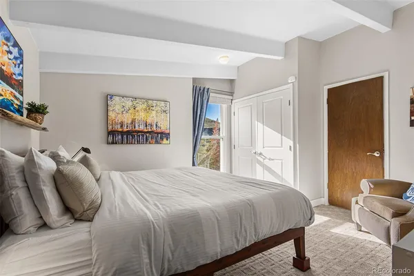 a bedroom with a bed and a couch