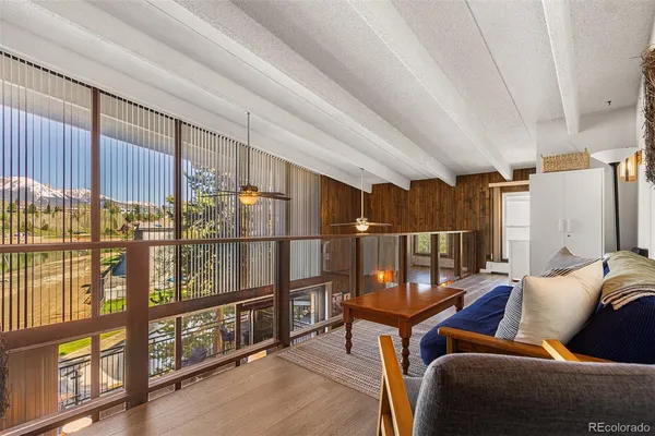 a living room with furniture a ceiling fan and a window
