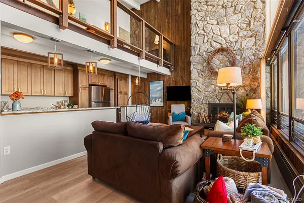 a living room with fireplace furniture and a wooden floor
